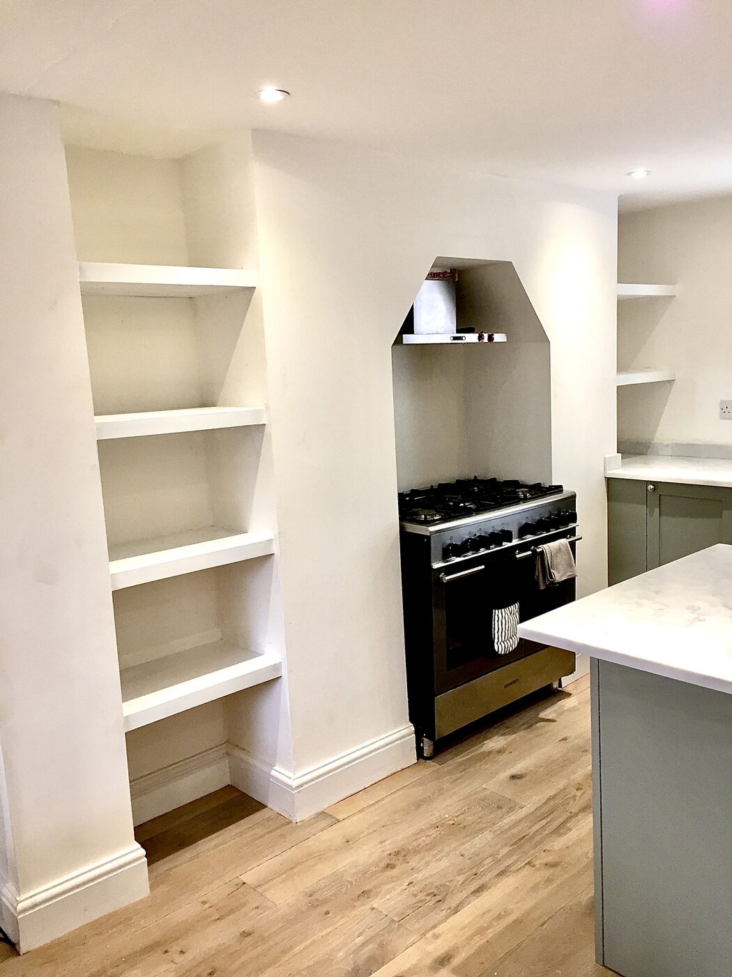 Finished white alcove shelving in a kitchen