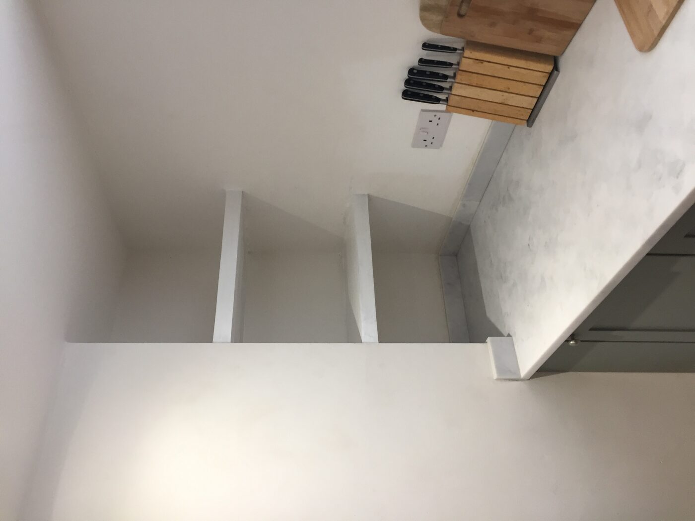 Corner shelves above a marble worktop