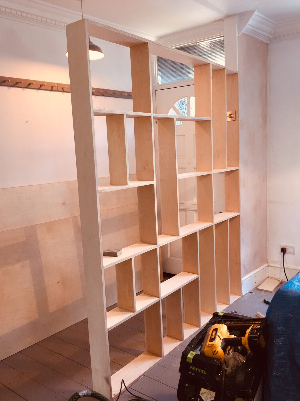Room divider shelving during construction
